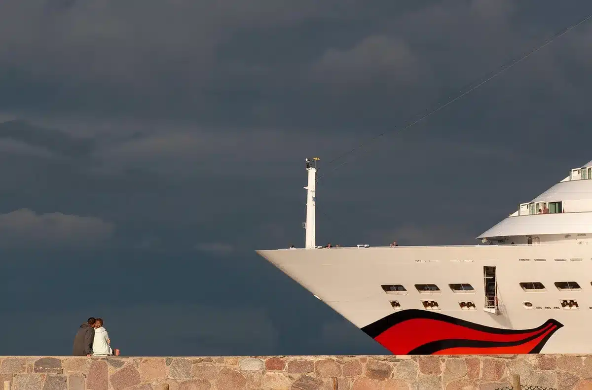 Casco de un patrullero visto desde un muelle en un astillero, silueta anónima